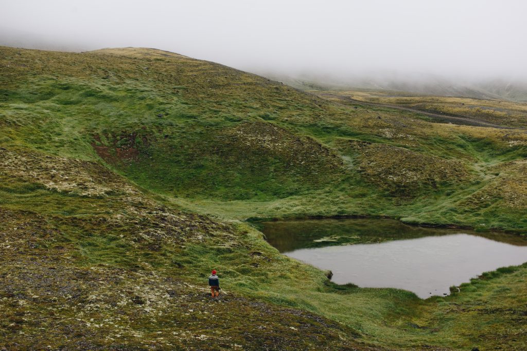 A traveller walks around the Icelandic landscape