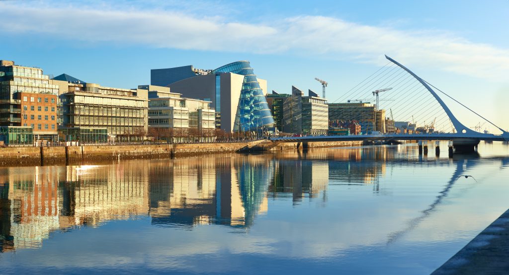 Modern Buildings on Liffey River in Dublin and Harp Bridge